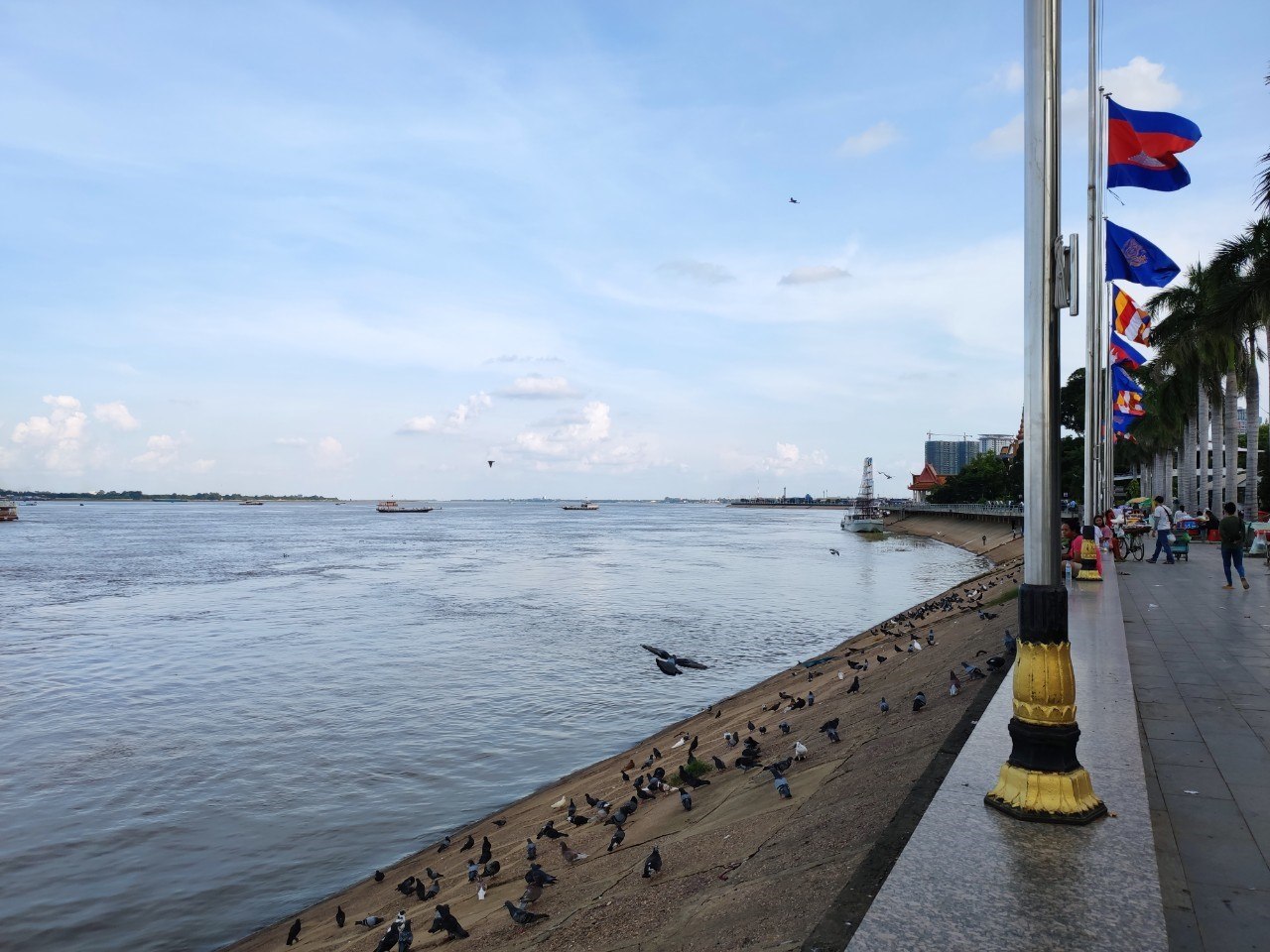 Riverside promenade with Cambodian flags